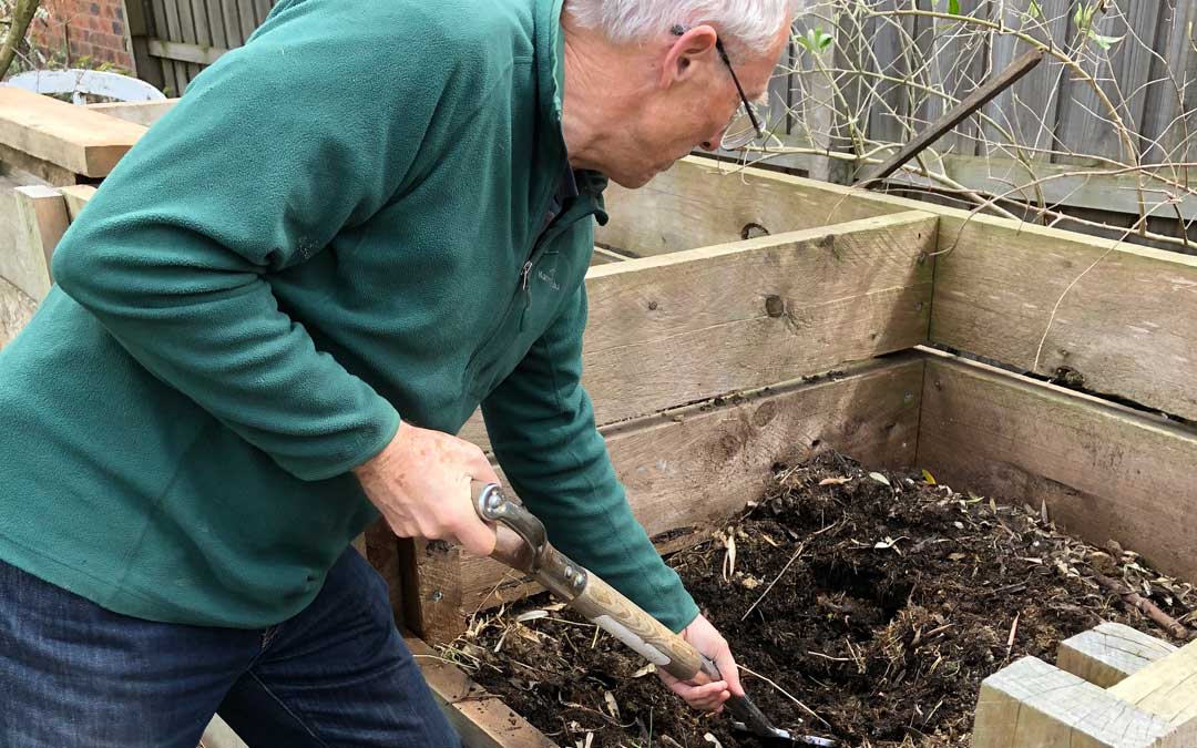 Paul digging compost when preparing a vegie garden
